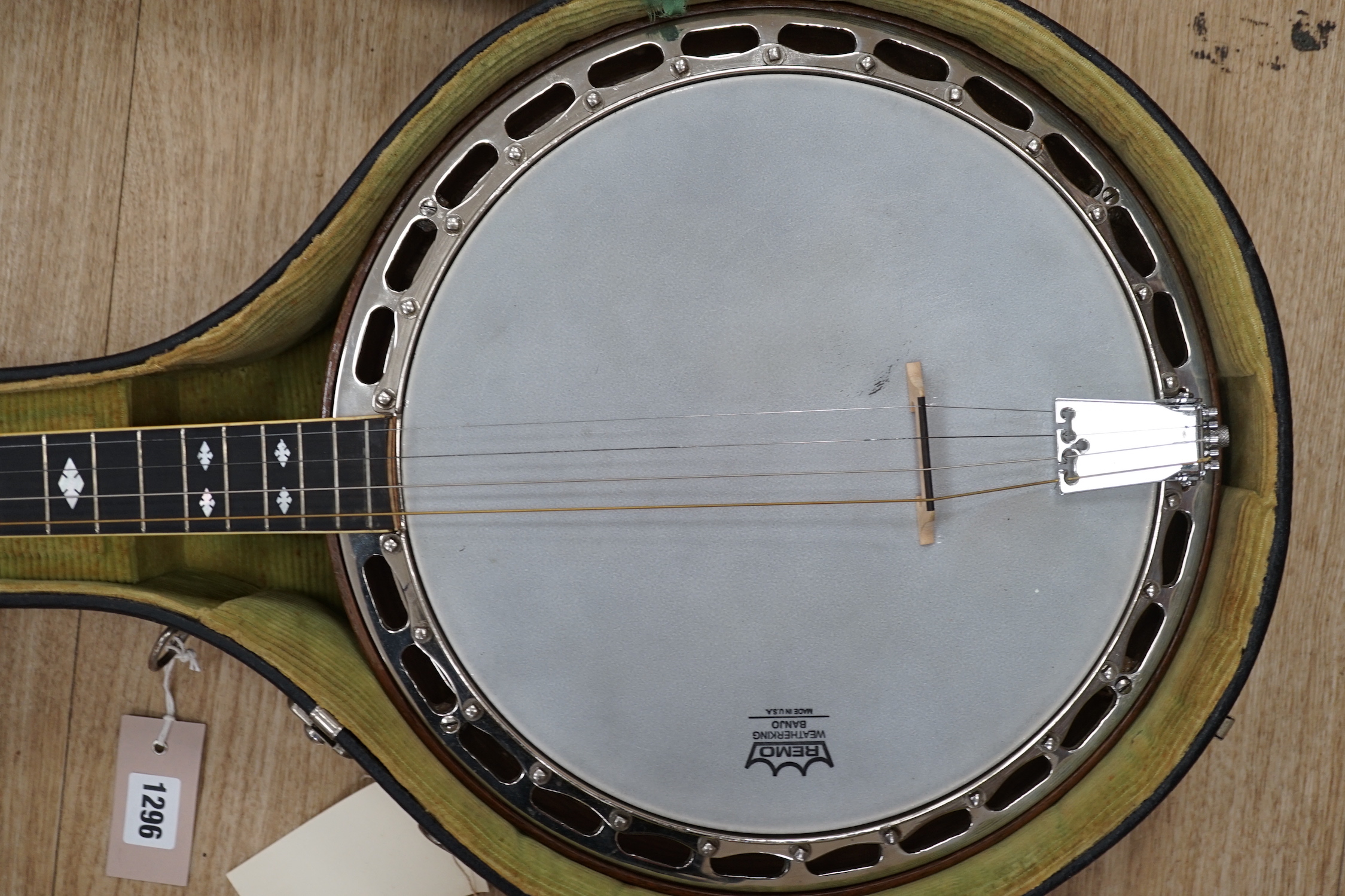 A cased 1920s Ludwig 'Kingston', USA tenor four string banjo, inlaid back, mother of pearl inlay to the fretboard, modern Remo skin, length of body 34cm, overall length 87cm, in a fitted hard case